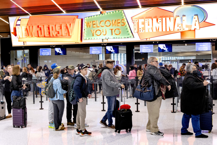 Travelers stand in line to pass through a security checkpoint at Terminal A at Newark Liberty International Airport (EWR) in Newark, N.J. on Jan. 12, 2023.