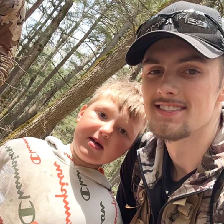 Nante Niemi,  8, stands with a volunteer after his rescue  in the Porcupine Mountains Wilderness State Park in Michigan on Monday.