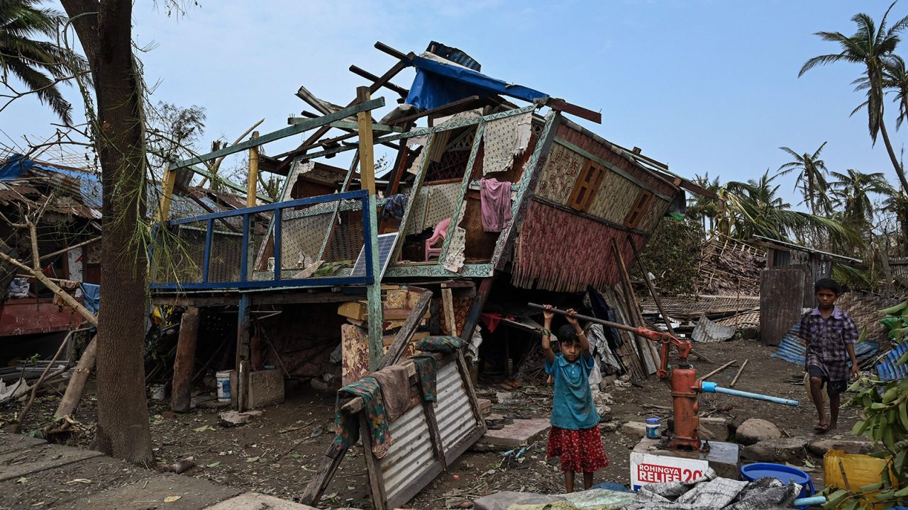 A girl draws water from a pump at Basara refugee camp in Sittwe on May 16 in the aftermath of Cyclone Mocha.