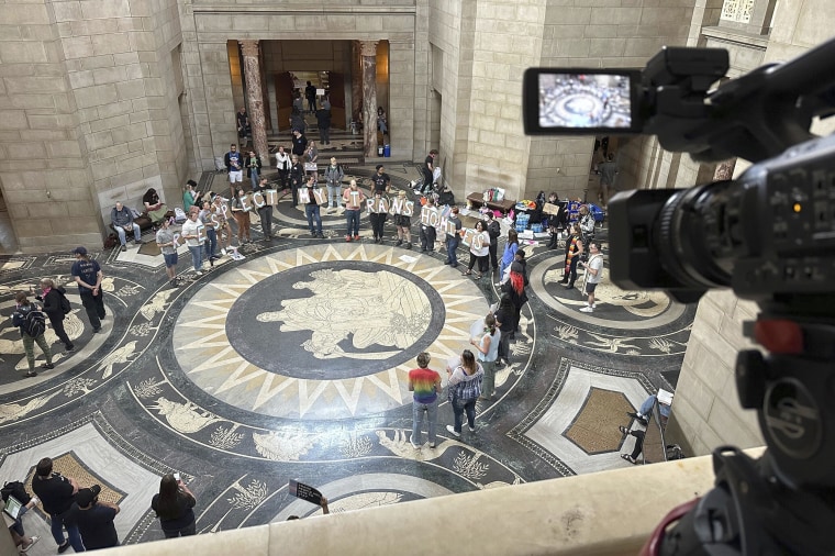 Protesters gather inside the State Capitol building on Friday, May 19, 2023, in Lincoln, Neb., before lawmakers were scheduled to begin debating a bill that will ban abortions at 12 weeks of pregnancy and also ban gender-affirming care for transgender minors. (AP Photo/Nick Ingram)
