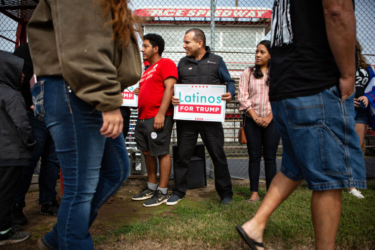 Omar Lugo, founder of the Latinos for Trump in Alamance County, holds a sign at Trump rally in Elon, N.C.