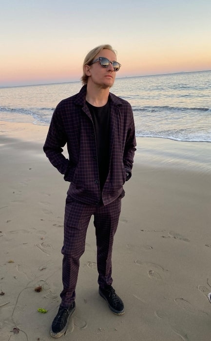 Jesse Johnson posing for a picture at a beach in November 2021