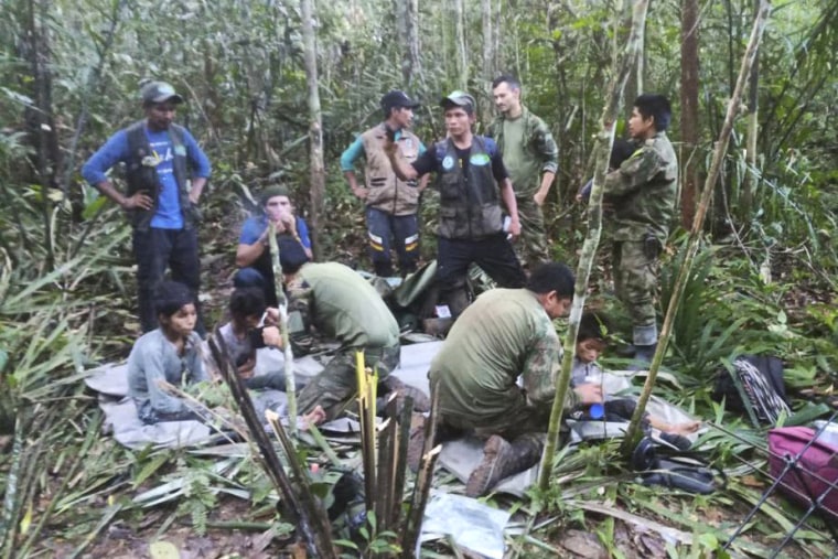 In this photo released by Colombia's Armed Forces Press Office, soldiers and Indigenous men tend to the four Indigenous brothers who were missing after a deadly plane crash, in the Solano jungle, Caqueta state, Colombia, Friday, June 9, 2023. Colombian President Gustavo Petro said Friday that authorities found alive the four children who survived a small plane crash 40 days ago and had been the subject of an intense search in the Amazon jungle.