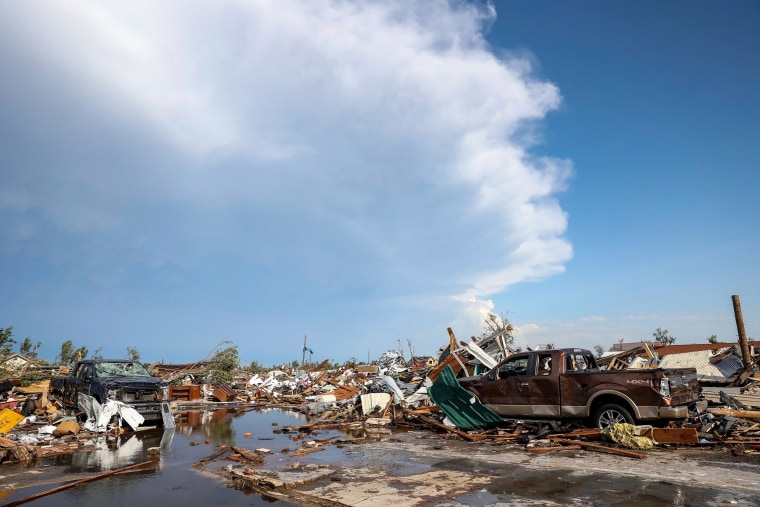Damaged pickup trucks sit among debris after a tornado passed through a residential area in Perryton, Texas, on June 15, 2023.