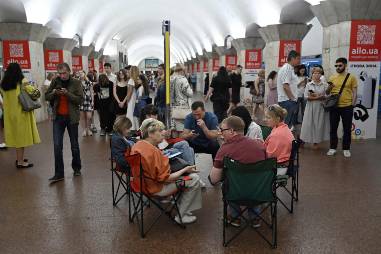 Local residents take shelter in a metro station in the center of Kyiv during a Russian missile attack