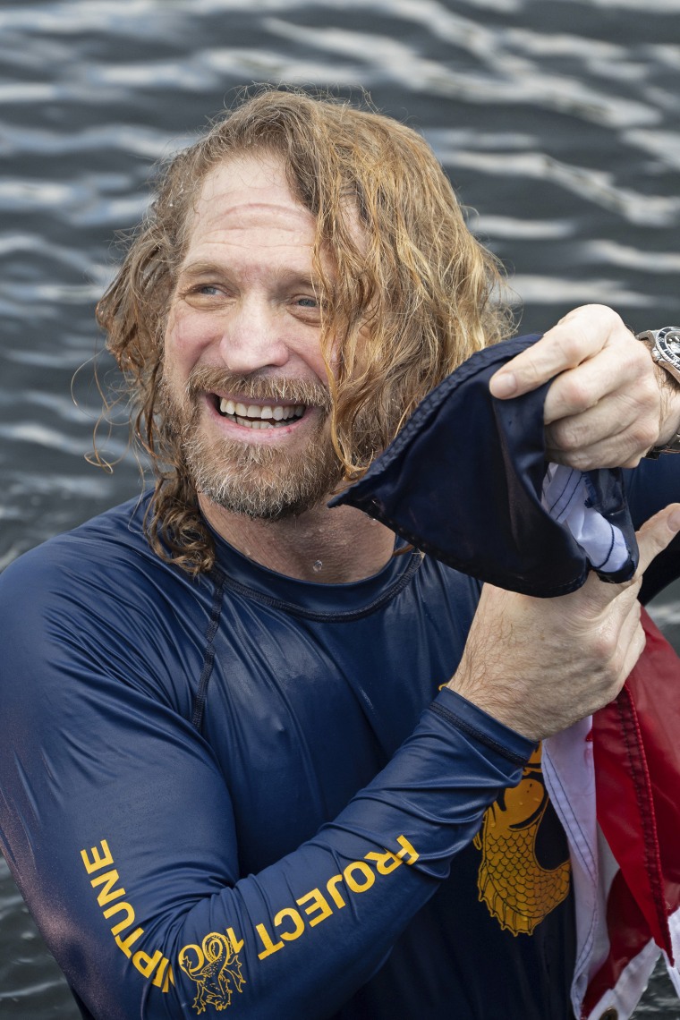 In this photo provided by the Florida Keys News Bureau, diving explorer and medical researcher Dr. Joseph Dituri emerges from the water Friday, June 9, 2023, after living for 100 days in the Jules' Undersea Lodge marine habitat at the bottom of a lagoon in Key Largo, Fla. Dituri broke the previous 73-day record for underwater human habitation at ambient pressure, undertook medical and marine science research and interacted online with more than 5,500 students during his Project Neptune 100 mission organized by the Marine Resources Development Foundation. (Andy Newman/Florida Keys News Bureau via AP)