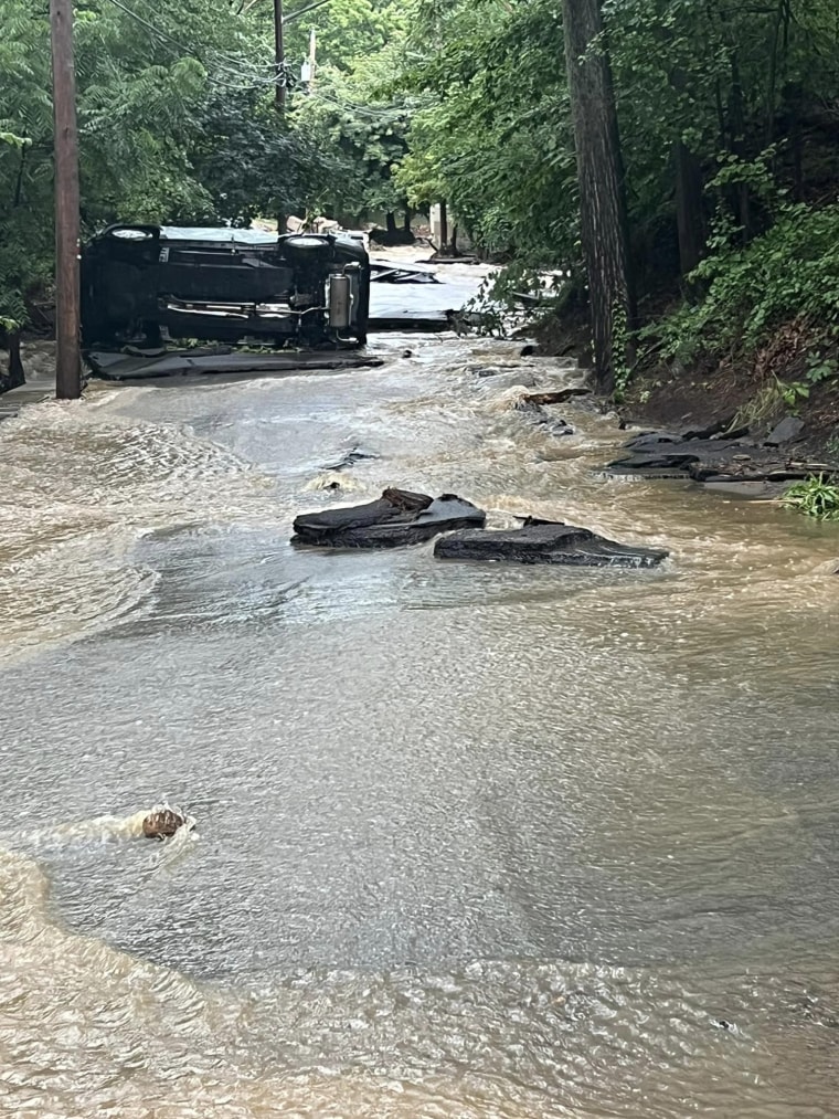 A vehicle on its side blocks a road Sunday in Orange County, New York.