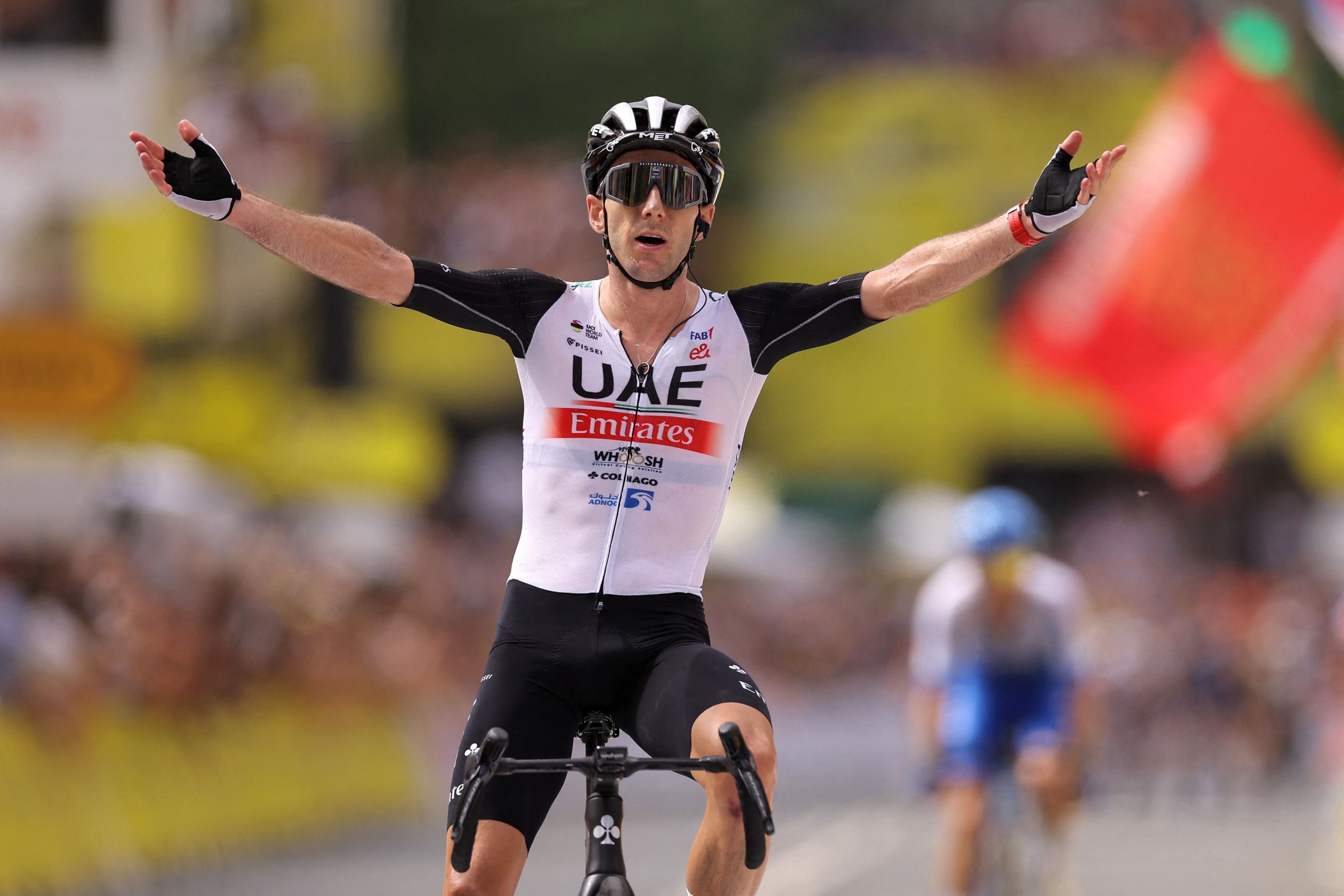 <p>Adam Yates celebrates claiming victory and the yellow jersey</p>