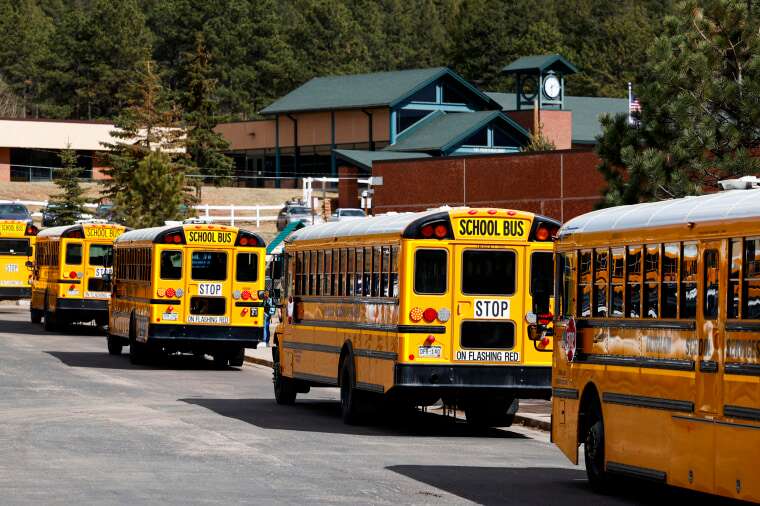 School busses arrive at Gateway Elementary School to pick up kids from school on April 12, 2023 in Woodland Park, Colo.