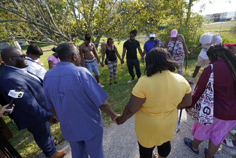 Residents gather for a prayer near the scene of a mass shooting at a Dollar General store, Saturday, Aug. 26, 2023, in Jacksonville, Fla.