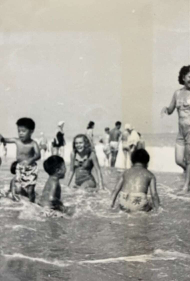 Large groups of Chinese American families and friends would set up their beach umbrellas while the children would paddleboard, attempt to surf the waves and play ball.