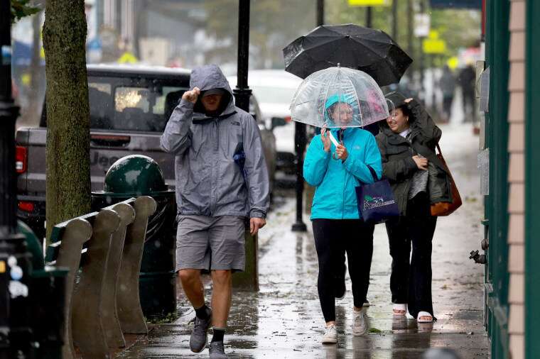 People walk in the rain and wind from storm Lee in Bar Harbor, Maine