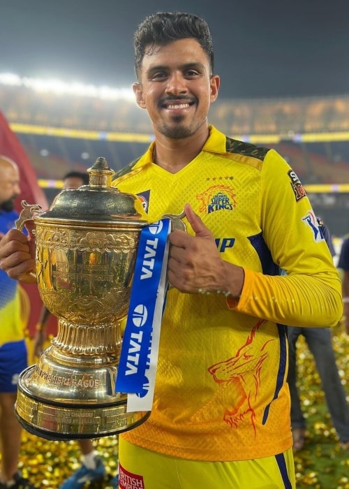 Maheesh Theekshana holding Indian Premiere League championship cup May 2023, at the Narendra Modi Stadium - Ahmedabad
