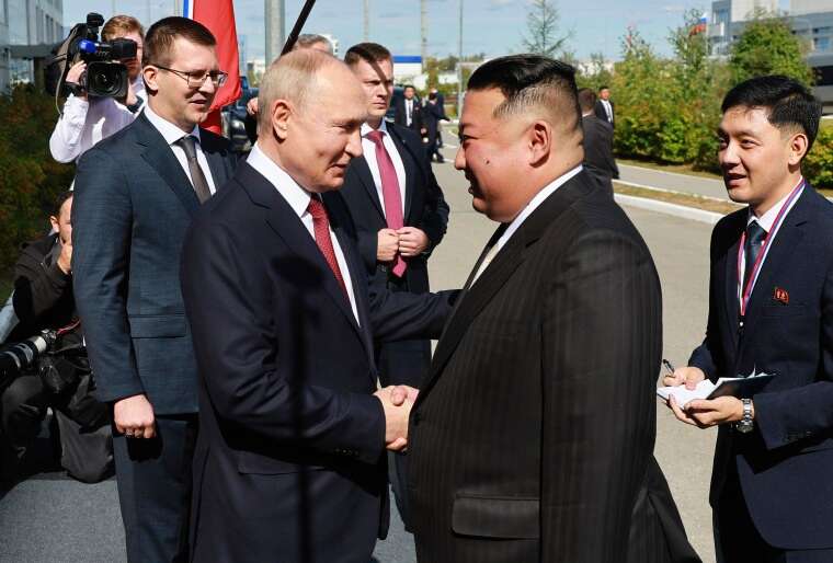 Russian President Vladimir Putin, left, and North Korea's leader Kim Jong Un shake hands during their meeting at the Vostochny spaceport outside the city of Tsiolkovsky, Russia, on Wednesday, Sept. 13, 2023. 