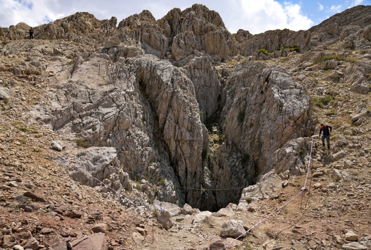 A Turkish officer walks next to the Morca Cave during rescue operations on Saturday, Sept. 9, 2023.