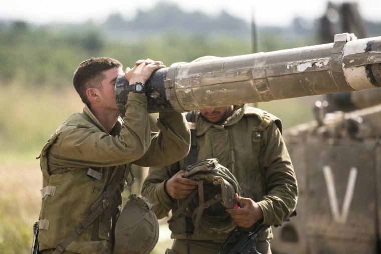 An Israeli soldier looks into a barrel of a tank on the Israeli border with the Gaza Strip on Oct. 19, 2023 in Sderot, Israel. 