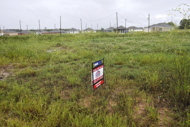 A "For Sale" sign on a vacant lot in the Santa Fe subdivision of the Colony Ridge development in Cleveland, Texas.