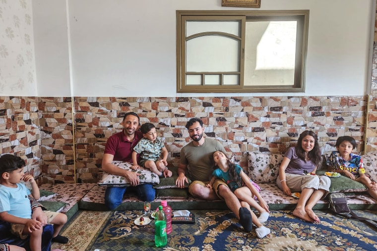 Hamed Alhayek shows his grandson Khaled Alhayek parts of their garden in their home in Gaza City's "Al Tofaha" neighborhood this past summer.