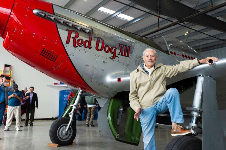 Harry Moyer in front of a P-51 Mustang fighter aircraft in Livermore, Calif.