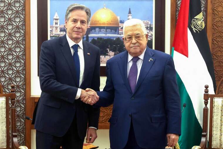 Mahmud Abbas and Secretary of State Antony Blinken shake handsduring a meeting.