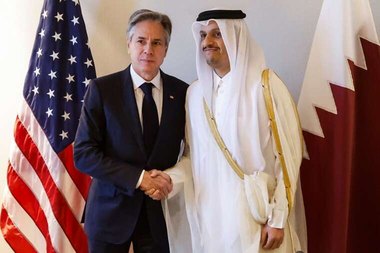 Anthony Blinken and Sheikh Mohammed bin Abdulrahman bin Jassim Al-Thani shake hands during a meeting in Amman.