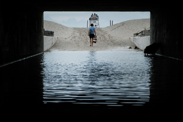 A teenager walks to Gilgo Beach in Babylon, New York on July 18, 2023. Rex Heuermann, a 59-year-old New York architect, has been charged with murdering three women and suspected in the death of a fourth.