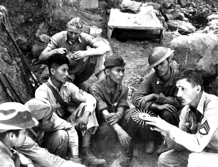 A U.S. Marine speaks to a group of Filipino soldiers on Corregidor Island in the Philippines in May 1942.