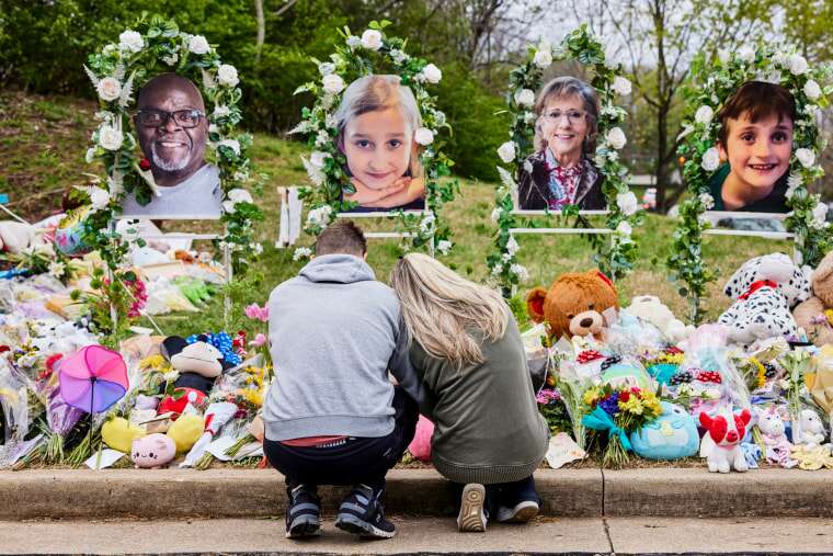 A couple prays at the memorial for the Covenant School shooting  victims at the Covenant School in Nashville Tenn. on March 31, 2023. 