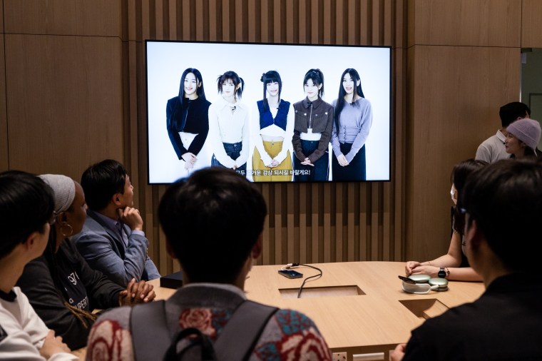 A video of K-pop girl band NewJeans on a screen during the opening of the Apple Inc. store in  Seoul, South Korea on March 31, 2023.