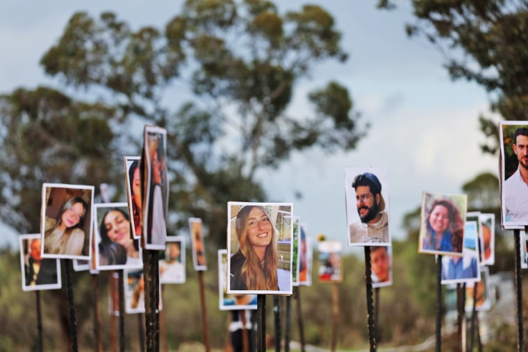 Pictures of victims of the Nova music festival attack are displayed at the site near Kibbutz Re'im and Israel's border with Gaza on Nov. 28, 2023.