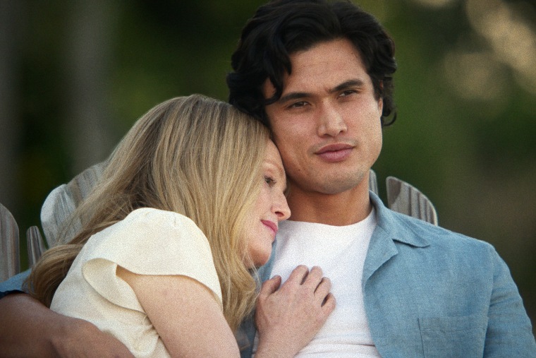 Julianne Moore puts her head on  Charles Melton's shoulder.