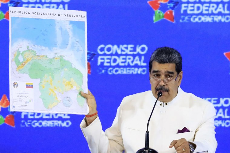 Venezuela's President Nicolas Maduro (R) speaking next to Bolivarian National Assembly President Jorge Rodriguez during a meeting of the Assembly of the Federal Council of Government at Miraflores Presidential Palace in Caracas on December 5, 2023.