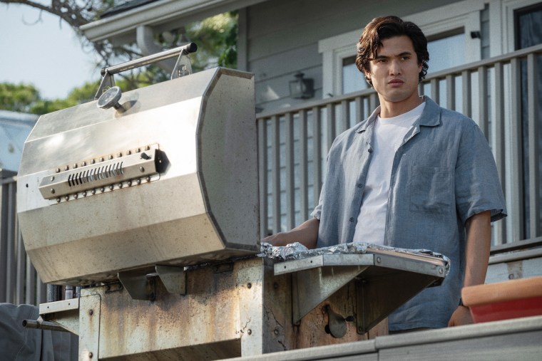 Charles Melton as Joe at the barbeque.