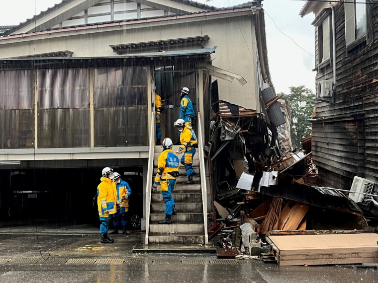 In Wajima, search and rescue crews went door-to-door to checking damaged houses for survivors or bodies. 