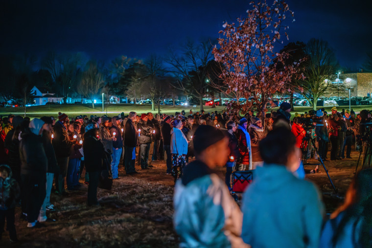 Community members gather Thursday at a candlelight vigil at Wiese Park to reflect on and mourn the shooting at the Perry Middle School and High School complex in Perry, Iowa.