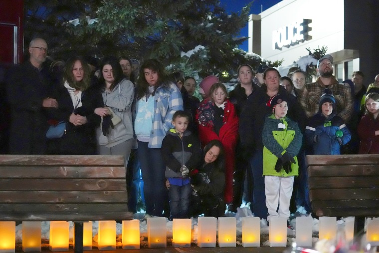 Mourners attend a vigil.