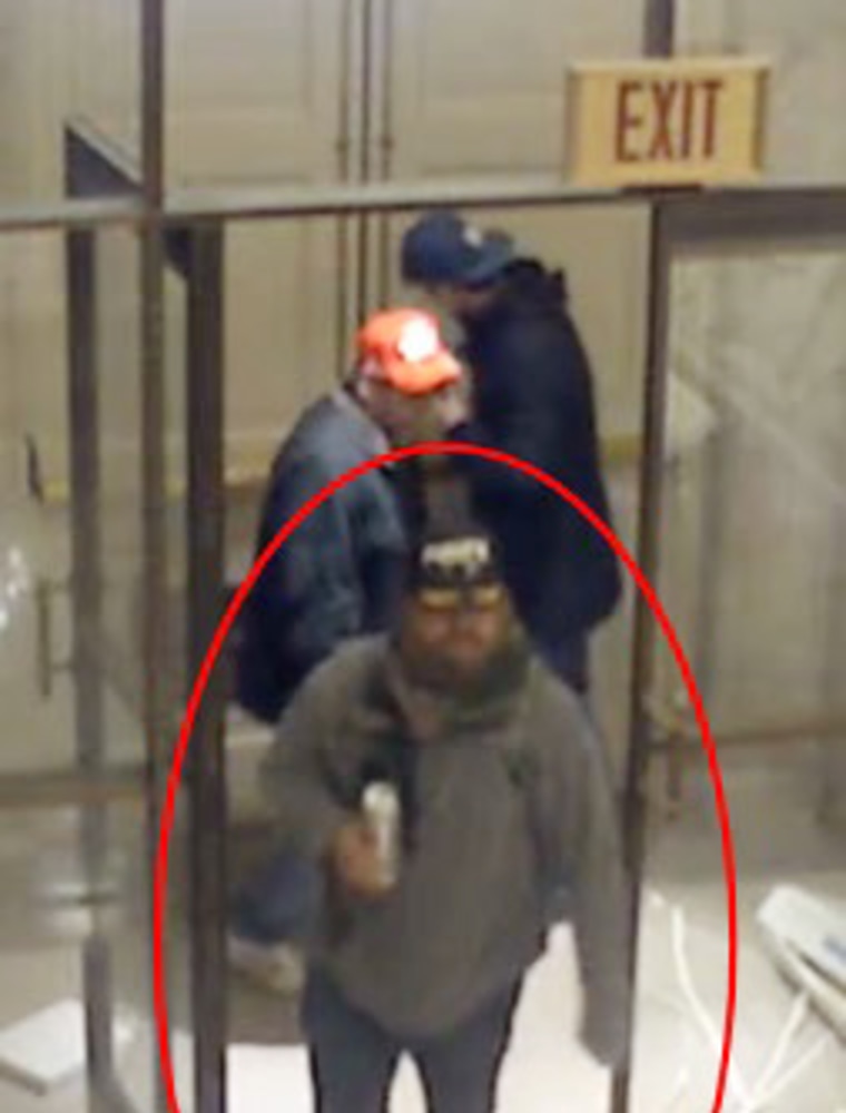 Miles Adkins near Law Library Door exit with a canned beverage.