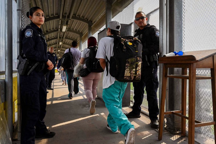 Migrants cross the Matamoros-Brownsville International Bridge 
