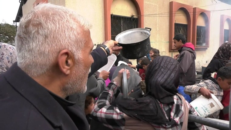 Magdy Hussein waits in line for food in Gaza.