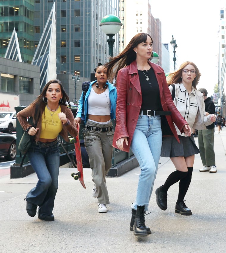 Isabela Merced running on the set of the movie outside a subway station.