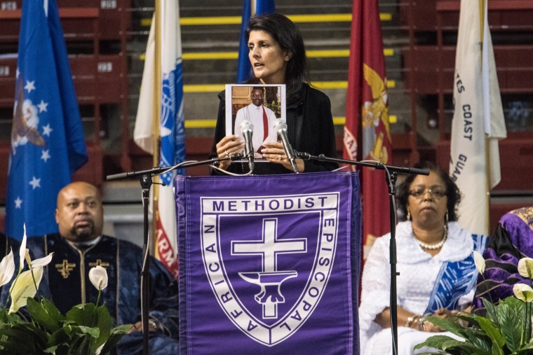 Former South Carolina Governor Nikki Haley holds up a photo of Clementa Pinckney during a memorial service remembering the victims of the mass shooting at Emanuel African Methodist Episcopal (AME) Church on June 17, 2016 in Charleston, S.C.  