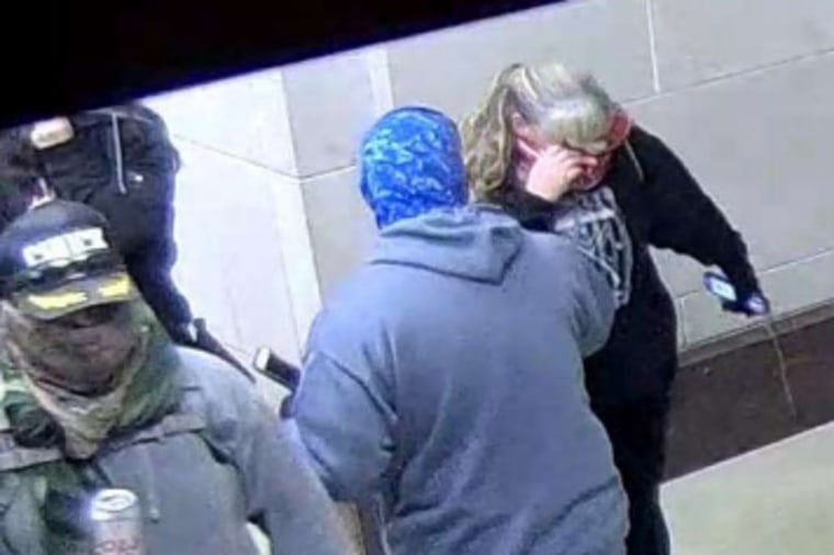 Miles Adkins, left, with a canned beverage inside the Capitol on Jan. 6, 2021.