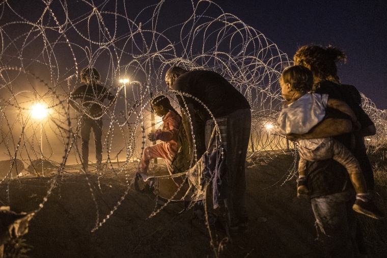 Immigrant families cross into the United States from Mexico to seek asylum