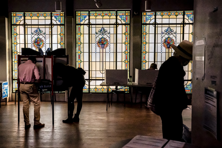 Image: Voters cast their ballots at a polling location inside the Museum of Contemporary Art on Nov. 8, 2022 in Arlington, Va.