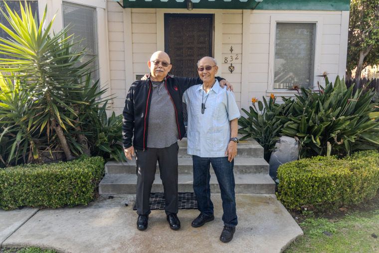 Brothers Lloyd Dong Jr., left, and his brother Ron stand outside of their childhood home on C Street in Coronado. 