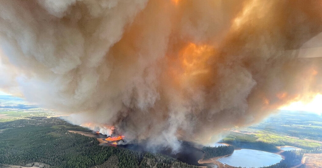 More than 13,000 Are Evacuated as Wildfires Burn in Western Canada