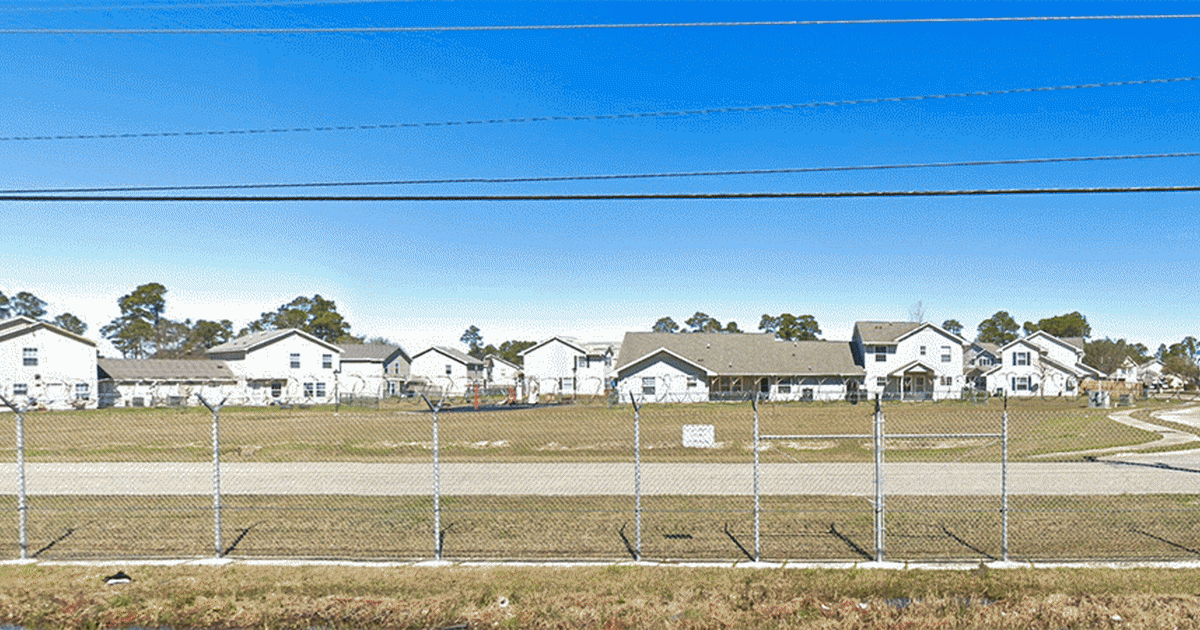 A Navy base put up a wall to ward off stray bullets. Locals say that doesn't to solve gun violence.
