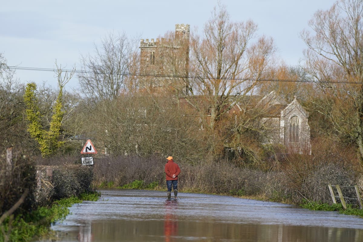 Hundreds of flood warnings issued as heavy rainfall disrupts roads - live
