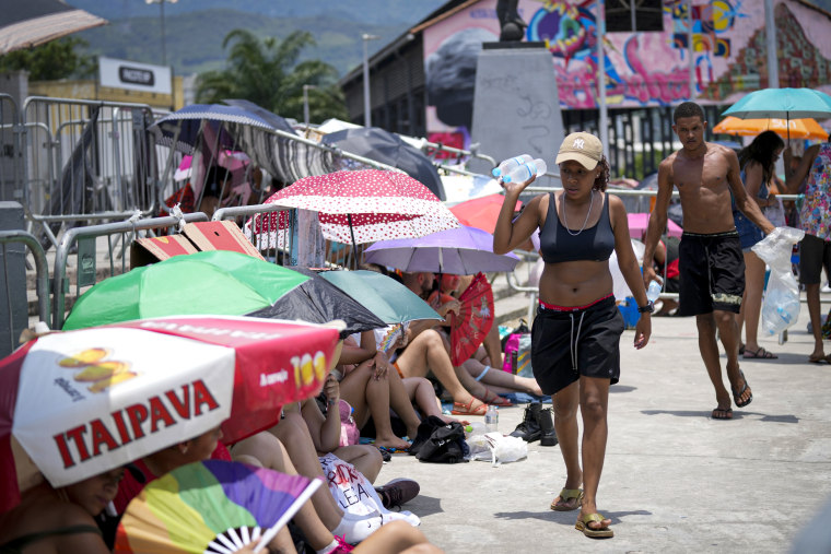 Street vendors sell bottled water to Taylor Swift fans outside the Nilton Santos Olympic stadium.
