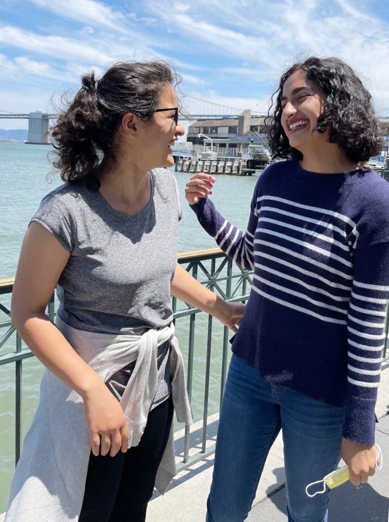 Sola Mahfouz and Malaina Kapour laugh while speaking.